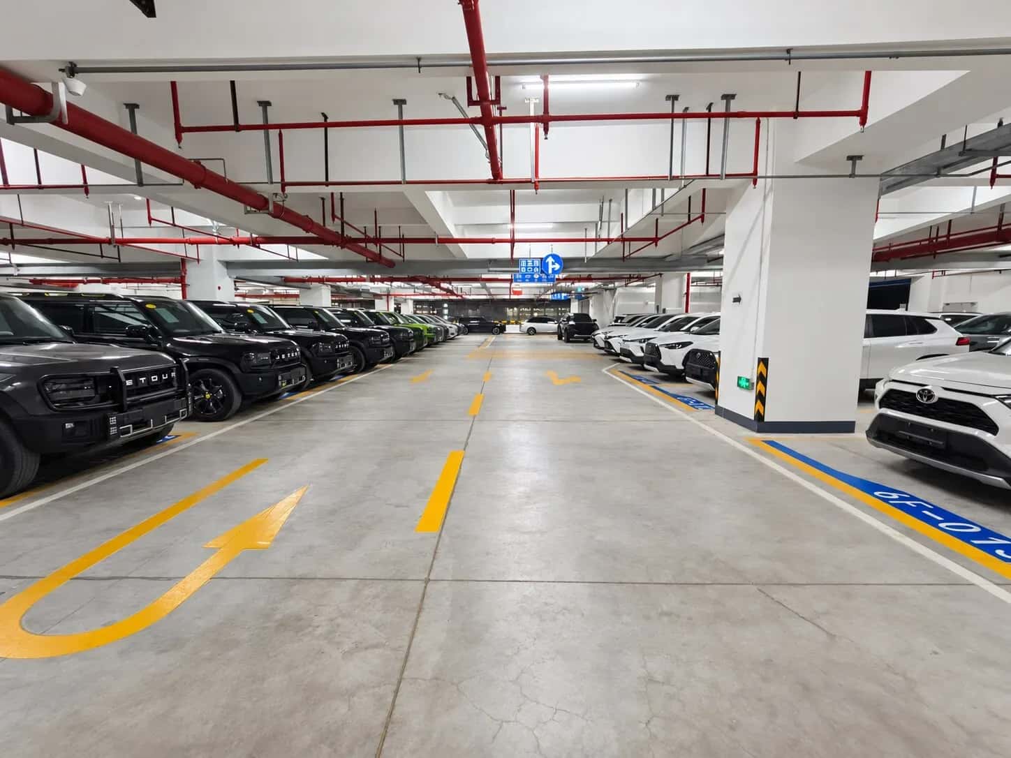 Vehicles arranged along the aisle of the OUO garage